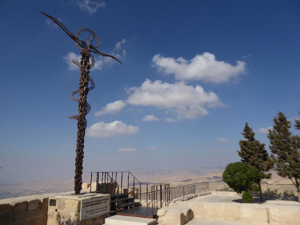 Mount Nebo Jordan, view of a intricately decorated cross and the Jordan valley down below, one of the best day trips from Amman