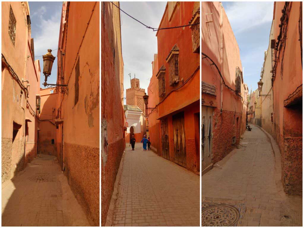 Alleys in the medina of Marrakech, orange and red colours, people walking