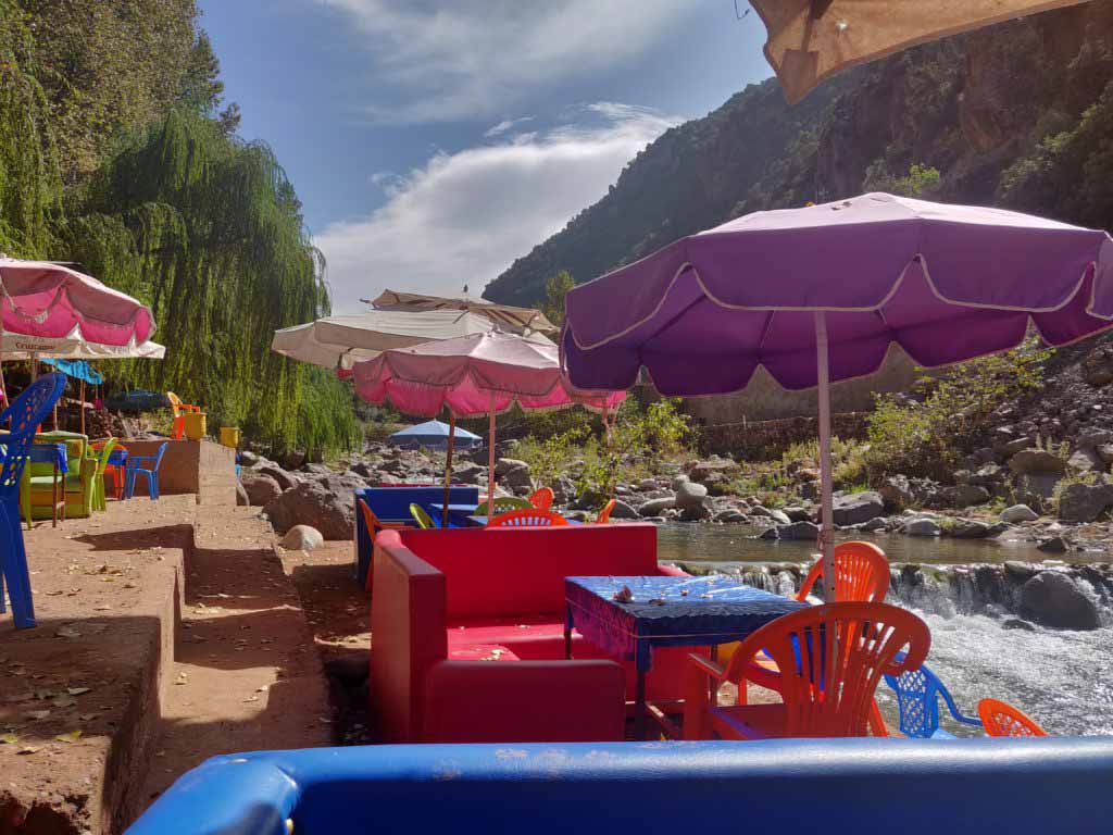 Chairs and tables on the river of Ourika valley, great for a day trip from Marrakech in the summer