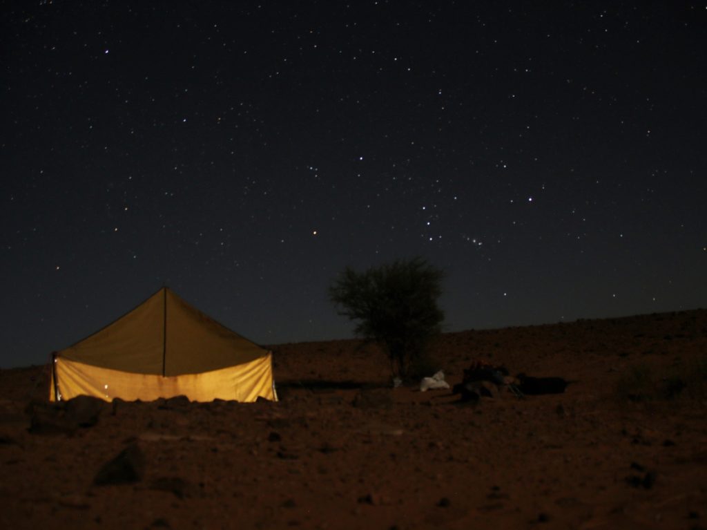 Illuminated berber tent, lots of stars visible in the sky