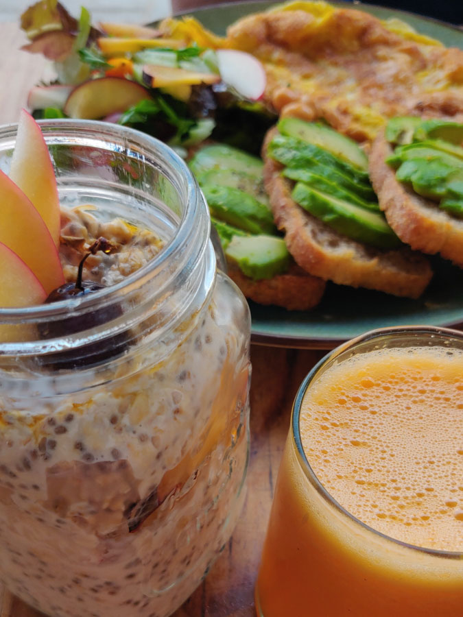 Breakfast at mandala restaurant in Essaouira, Morocco. Chia with fruit in glass, avocado toast, fresh juice